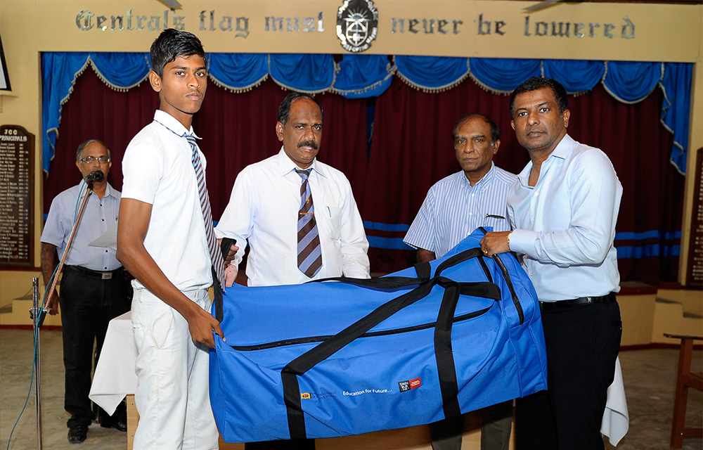 Jaffna Central College principal and cricket captain accepting the cricket gear from Mr. Victor Rajeevan, CEO of NCHS and Mr. Jaya Rudra, Director of NCHS.